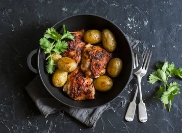 Golden Herb Cast Iron Roast Chicken and Crispy Garlic Potatoes